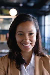 portrait-mixed-race-businesswoman-wearing-smart-clothes-working-modern-office-smiling-looking-straight-into-camera_13339-314521