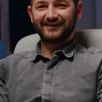 portrait-smiling-businessman-sitting-desk-table-business-company-office_482257-5560