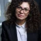 young-woman-with-curly-hair-business-attire-office_254309-1016